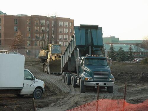 20-DumpTruckDumpingGravelFromFront-11-26-03